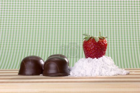 Photo for Fresh strawberry on sugar powder and chocolates - Royalty Free Image