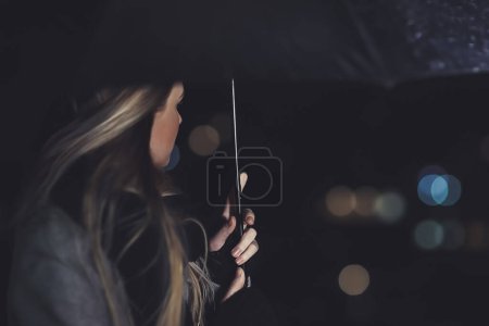 Photo for Female outdoors in rainy night - Royalty Free Image
