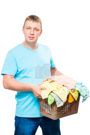 Photo for Vertical portrait of a man with a basket of clean linen - Royalty Free Image