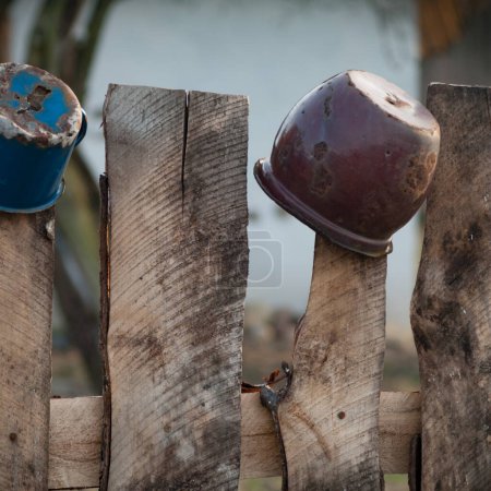 Photo for Old rusty fence with a metal pot - Royalty Free Image
