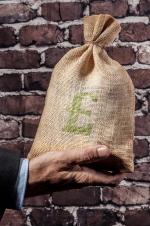 Photo for Man holding bag with pound sign - Royalty Free Image