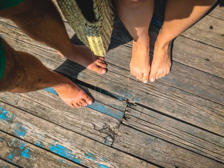 Photo for "Top view, photo of a pair of bare feet on a wooden old floor. Ph" - Royalty Free Image