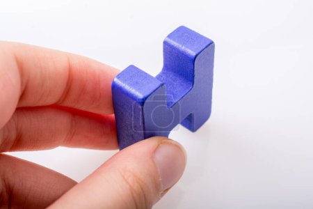 Photo for "Hand holding Letter cube H of made of wood" - Royalty Free Image