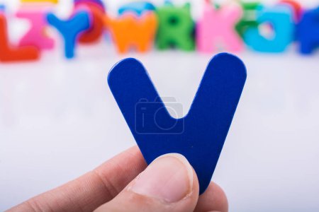 Photo for "Hand holding Letter cube V of  Alphabet" - Royalty Free Image