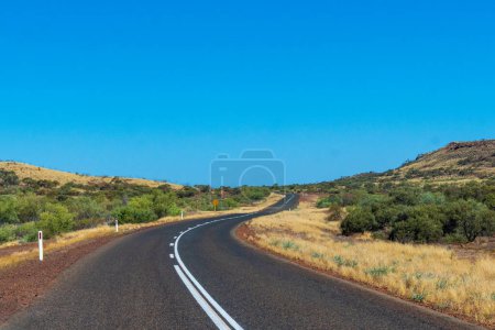 Photo for "Purple iron ore sand next to road at Karijini National Park Australia" - Royalty Free Image
