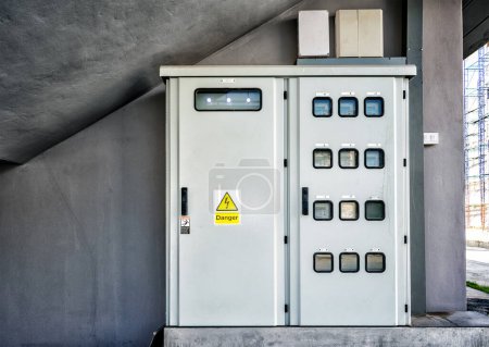 Photo for "Functioning Electric Meter Panel with a Danger Sign." - Royalty Free Image