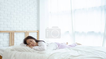 Photo for Young Asian woman in bed. Health concept in sleep - Royalty Free Image