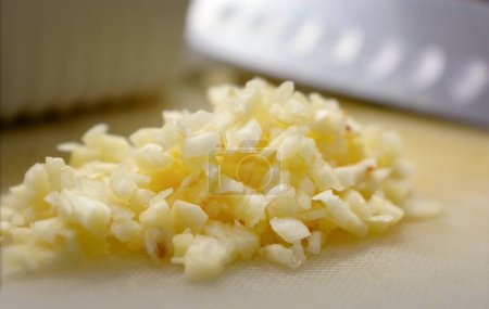 Photo for Minced Garlic on a Plastic Cutting Board. - Royalty Free Image