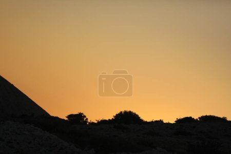 Photo for Matte yellow sunset in the rocks of Adriatic sea - Royalty Free Image