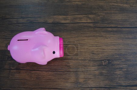 Photo for Pink piggy bank on wooden table - Royalty Free Image