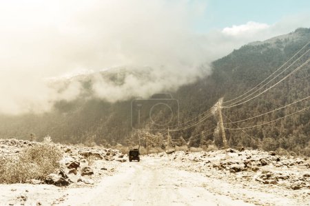 Photo for Off-road vehicle goes on the mountain way during the winter rainy season in Himalayan mountain range Gangtok Sikkim India. - Royalty Free Image