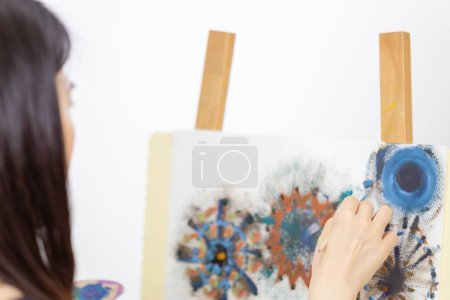 Photo for Artist painting on an easel - Royalty Free Image