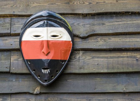 Photo for Classical african mask on a wooden wall background, Culture in Africa, traditional background - Royalty Free Image
