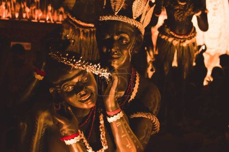 Foto de KOLKATA, INDIA SEPTIEMBRE 26, 2017 - Arte decorado y esculturas artesanales de Santal tradicional tribal o grupo étnico Santhal bailarines haciendo el amor llevar ropa tradicional en la famosa Durga Puja pandal
. - Imagen libre de derechos