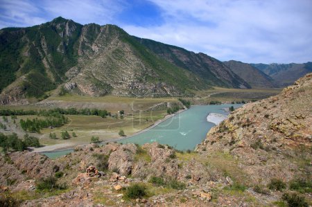 Téléchargez les photos : La rivière turquoise coule dans la vallée au pied des montagnes
. - en image libre de droit