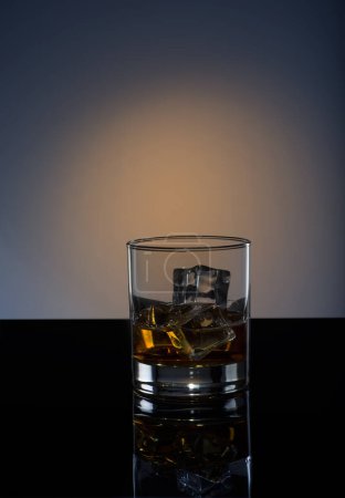 Photo for Whiskey with ice on a black background - Royalty Free Image