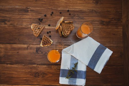 Photo for Breakfast for two. freshly squeezed juice and wafers - Royalty Free Image