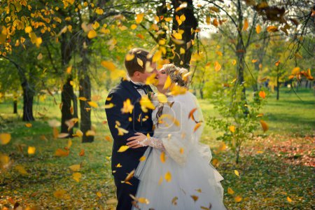 Foto de Beso de una pareja recién casada en un parque de otoño - Imagen libre de derechos