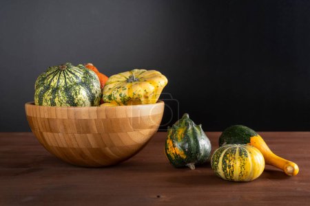 Photo for Small pumpkins on wooden table - Royalty Free Image