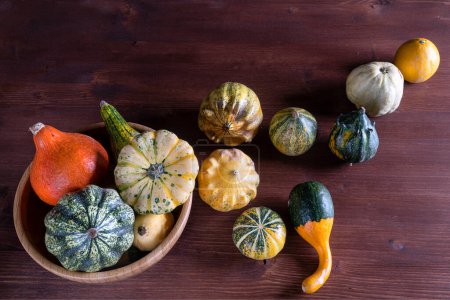 Photo for Small pumpkins on wooden table - Royalty Free Image