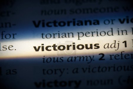 Photo for Victorious word, highlighted in dictionary, close up view - Royalty Free Image