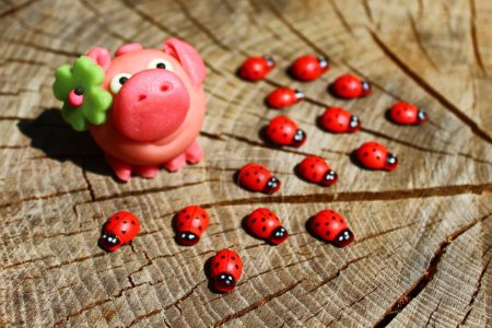Photo for Good luck wishes. Toy piggy and ladybirds - Royalty Free Image