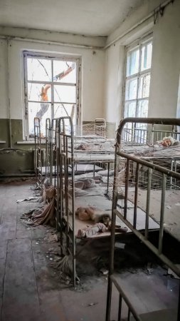 Photo for Empty children's beds in an abandoned kindergarten house - Royalty Free Image