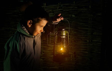 Photo for Child walk in the darkness with lantern - Royalty Free Image