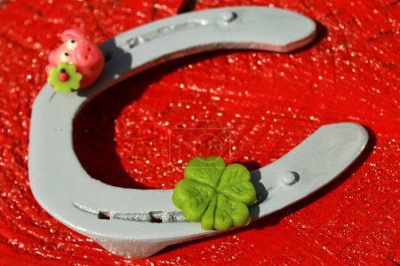 Photo for Horseshoe with lucky clover and a marzipan pig - Royalty Free Image