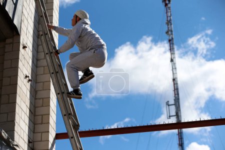 Photo for Man climb up the ledder - Royalty Free Image