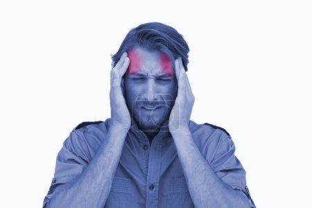 Photo for Man wincing with pain of headache - Royalty Free Image