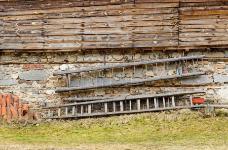 Photo for Ancient hayloft with stone wall from below, wooden plank from above and cart-ladder in the wall, Koprivshtitsa - Royalty Free Image