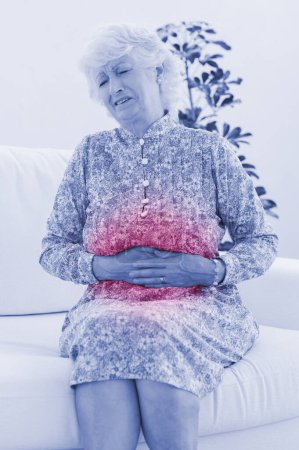 Photo for Elderly woman suffering with a belly pain - Royalty Free Image