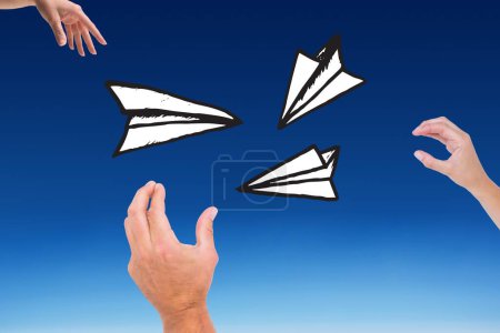 Foto de Compuesto de manos que están lanzando avión de papel - Imagen libre de derechos