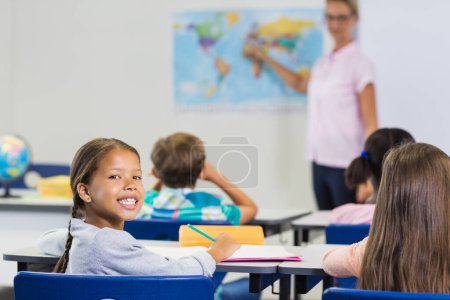 Photo for Teacher having lesson with map - Royalty Free Image