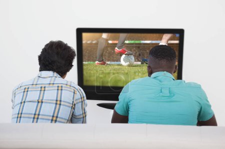 Téléchargez les photos : Image composite de deux fans de football regardant la télévision - en image libre de droit