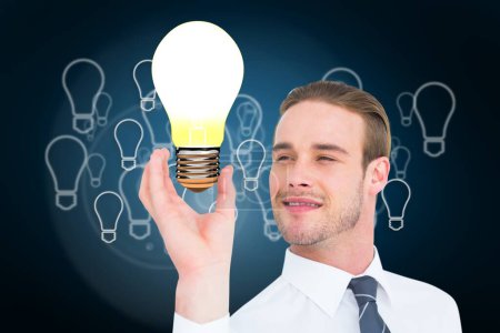 Photo for Man holding a light bulb - Royalty Free Image