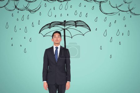 Photo for Young businessman with a drawn umbrella and rain - Royalty Free Image