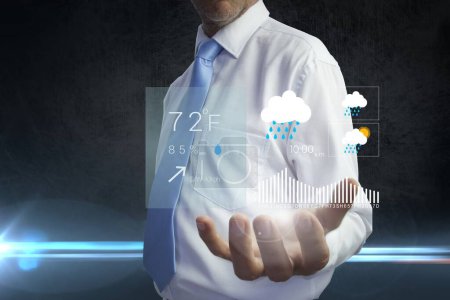 Photo for Businessman holding a weather forecast hologram - Royalty Free Image