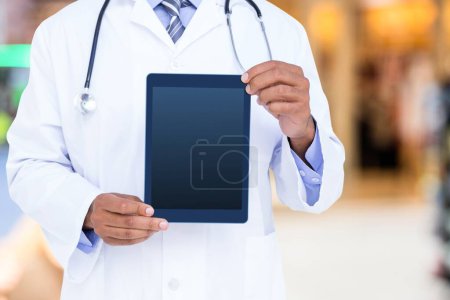 Photo for Cropped view of Doctor holding a digital tablet - Royalty Free Image