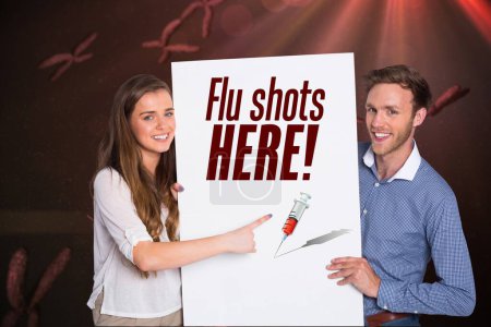 Photo for Young couple holding flu shots here sign - Royalty Free Image
