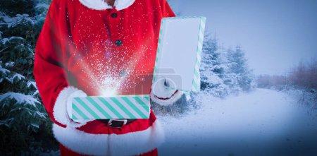 Photo for Composite image of midsection of santa claus opening gift box - Royalty Free Image