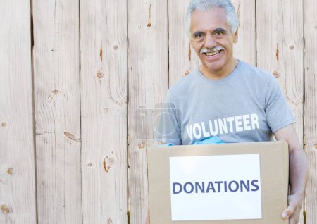 Photo for Digital composite of volunteer holding donation box - Royalty Free Image