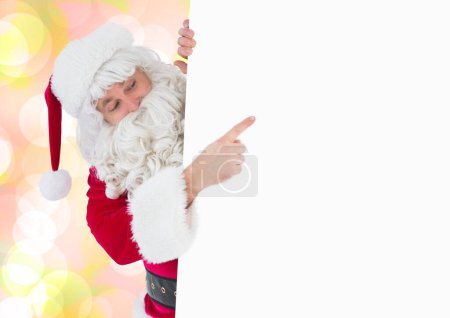Téléchargez les photos : Santa pointant carte blanche sur fond coloré - en image libre de droit