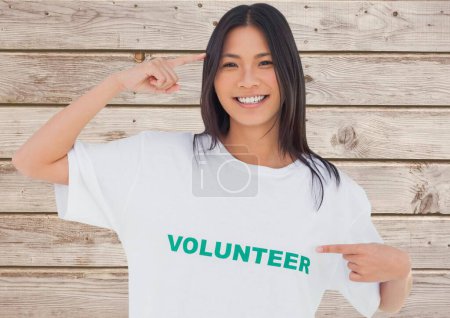 Photo for Smiling volunteer against wooden background - Royalty Free Image