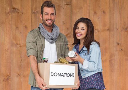 Photo for Cheerful couple with donation box - Royalty Free Image