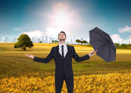 Photo for Businessman in green field with umbrella. business concept - Royalty Free Image