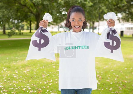 Photo for Young volunteer woman with money bag - Royalty Free Image