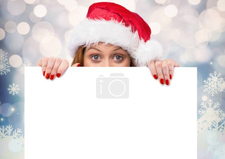 Photo for Woman showing whitecard against blurry background - Royalty Free Image