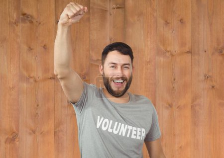 Photo for Picture of enjoying volunteer against wooden background - Royalty Free Image